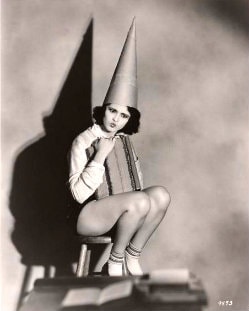 Girl in dunce cap (for not knowing about vaccinations' harmful effects).